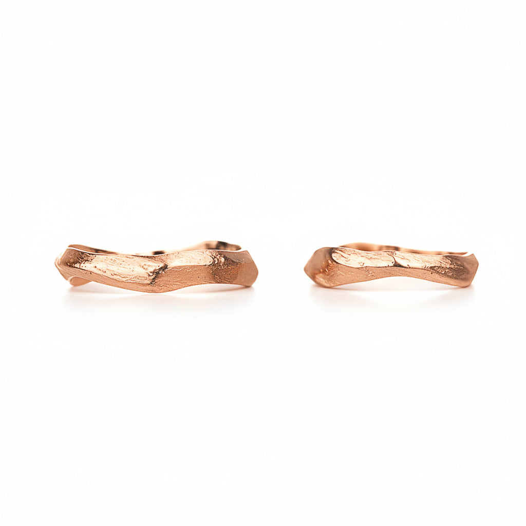 Pair of rose gold twig-shaped wedding rings