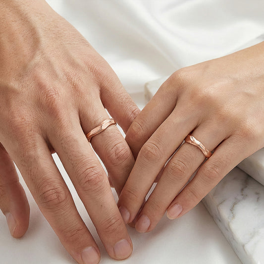 Pair of rose gold twig-shaped wedding rings