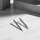 Skyline earrings sterling silver with ebony wood. A pair of silver earrings with a geometric design, featuring a slender vertical element.