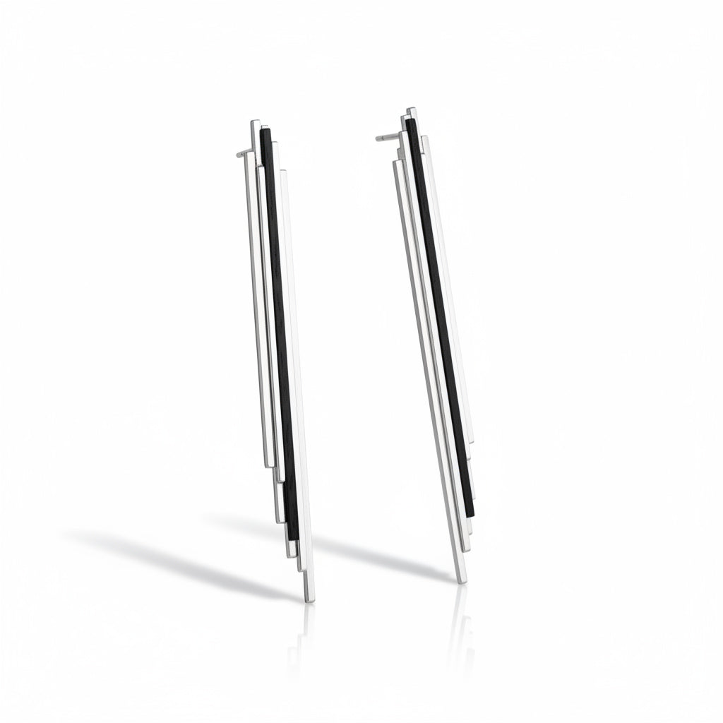 Skyline earrings sterling silver with ebony wood. A pair of silver earrings with a geometric design, featuring a slender vertical element.